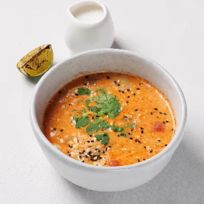 Tom yum soup in a white bowl